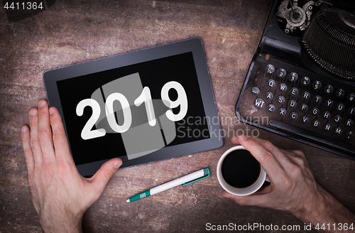 Image of Tablet touch computer gadget on wooden table - 2019