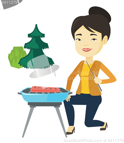 Image of Woman cooking steak on barbecue grill.