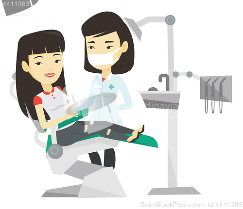 Image of Patient and doctor at dentist office.