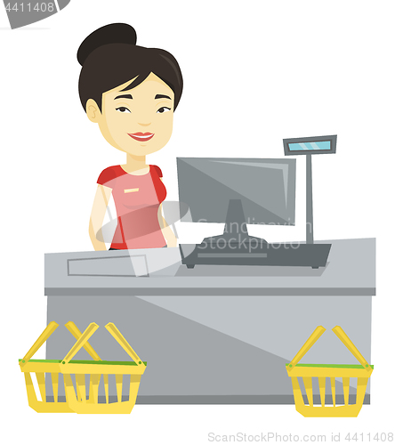 Image of Cashier standing at the checkout in supermarket.