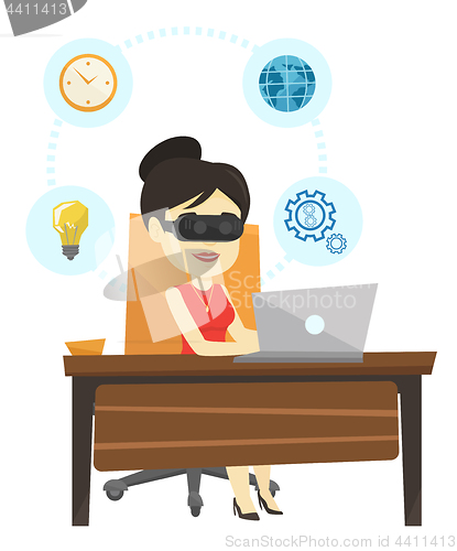 Image of Business woman in vr headset working on computer.