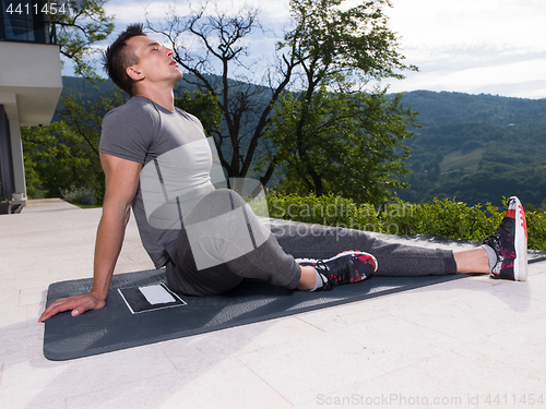 Image of man doing morning yoga exercises