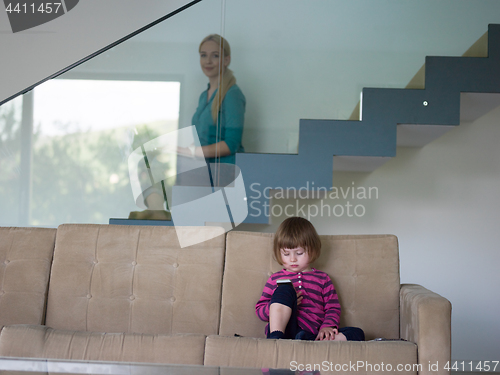 Image of little girl playing games on smartphone