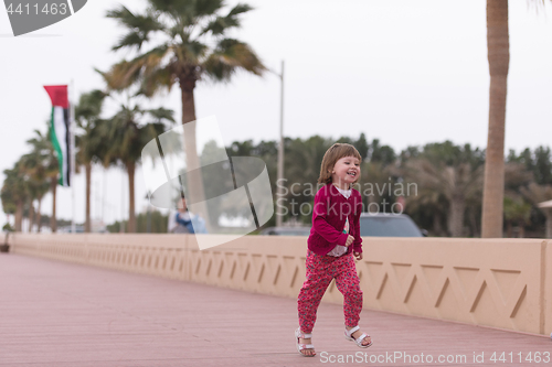 Image of cute little girl on the promenade by the sea