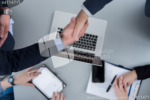 Image of cloasing the deal in modern office interior top view