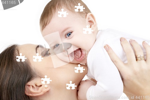 Image of puzzle of laughing baby playing with mother