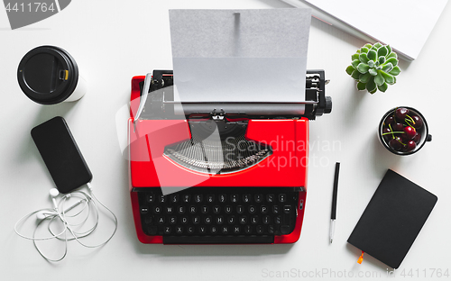 Image of Workplace with bright red vintage typewriter