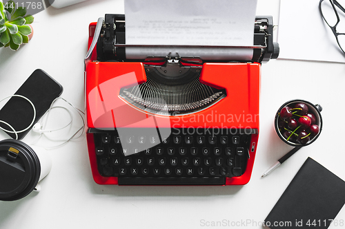 Image of Workplace with bright red vintage typewriter