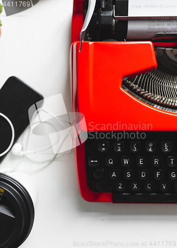 Image of Workplace with bright red vintage typewriter