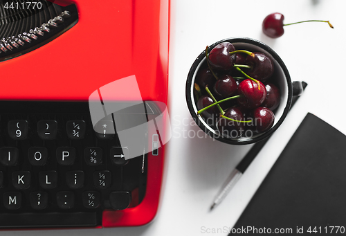 Image of Workplace with bright red vintage typewriter