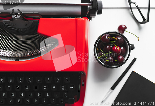 Image of Workplace with bright red vintage typewriter