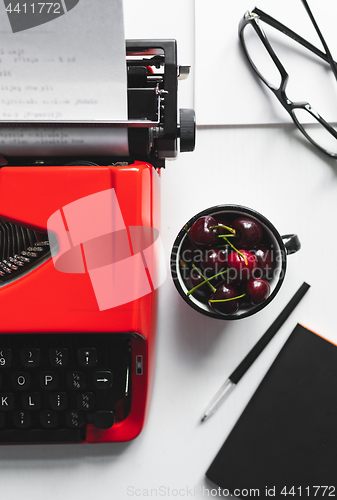 Image of Workplace with bright red vintage typewriter
