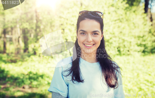 Image of happy young volunteer woman outdoors