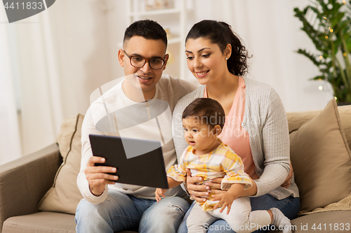 Image of mother, father and baby with tablet pc at home