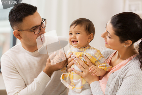 Image of happy family with baby daughter at home