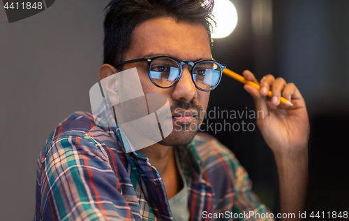 Image of close up of creative man working at night office