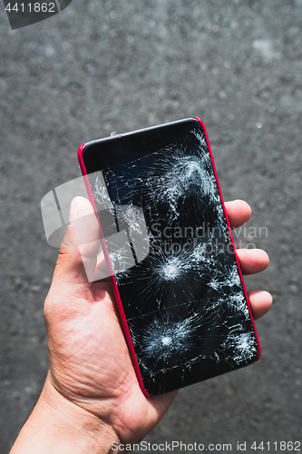 Image of Person holding broken smartphone