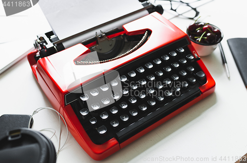 Image of Workplace with bright red vintage typewriter