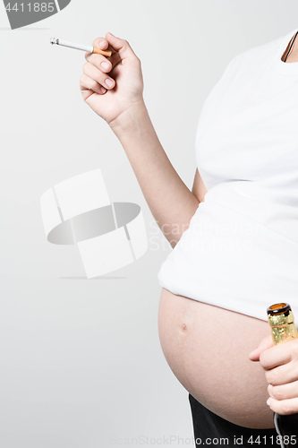 Image of Pregnant woman with beer and cigarette