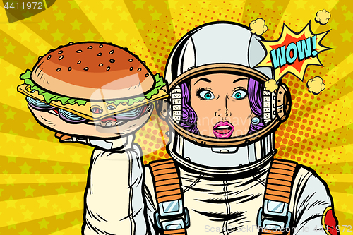 Image of Hungry woman astronaut with Burger