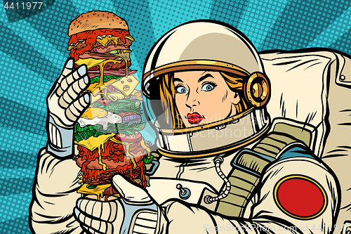 Image of Hungry woman astronaut with giant Burger