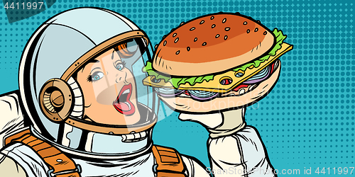 Image of Hungry woman astronaut eating Burger