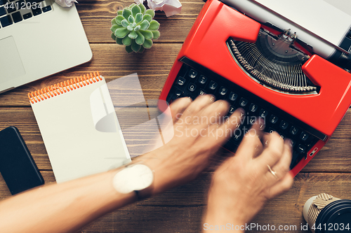 Image of Top view of man using typewriter