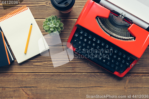 Image of Vintage typewriter on wooden background