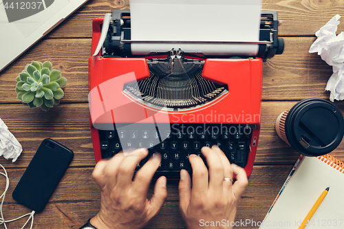 Image of Top view of man using typewriter