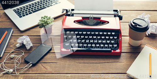 Image of Vintage typewriter on wooden background