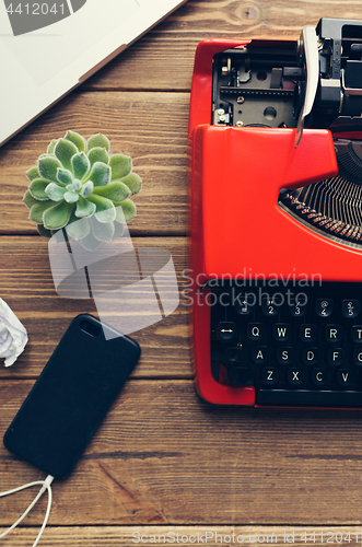 Image of Vintage typewriter on wooden background