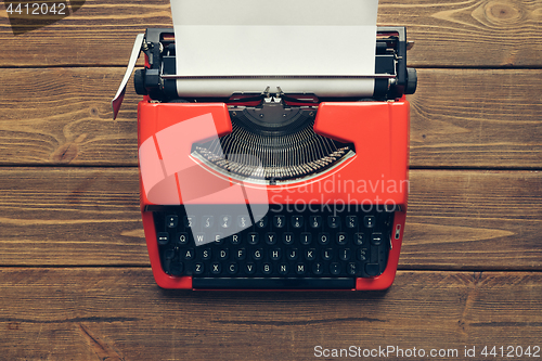 Image of Vintage typewriter on wooden background