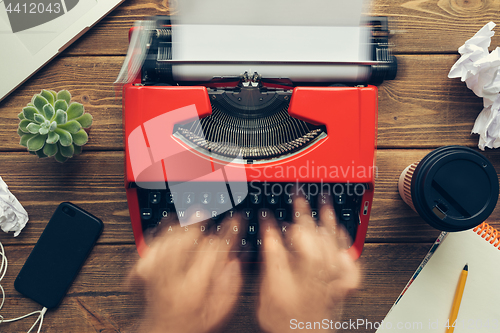 Image of Top view of man using typewriter