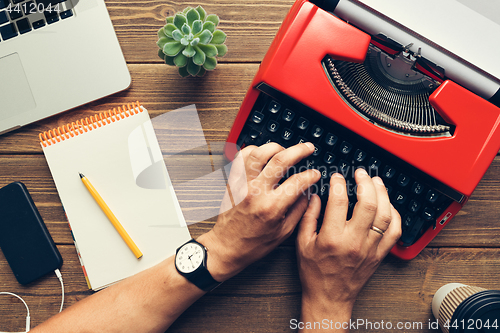 Image of Top view of man using typewriter