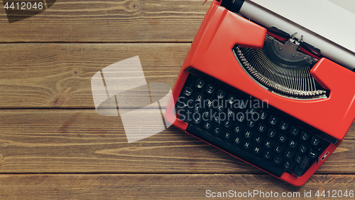 Image of Vintage typewriter on wooden background