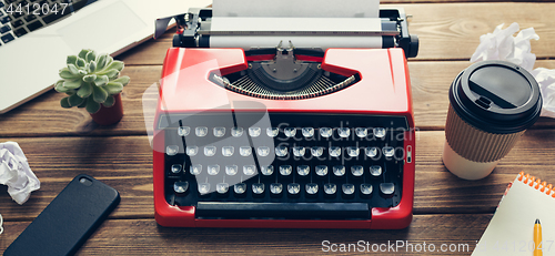 Image of Vintage typewriter on wooden background