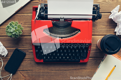 Image of Vintage typewriter on wooden background