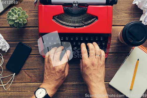 Image of Top view of man using typewriter