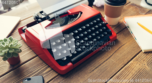 Image of Vintage typewriter on wooden background