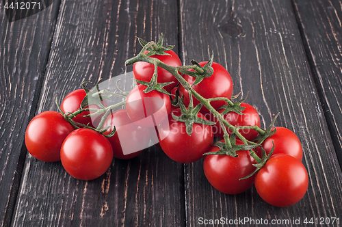Image of Branches cherry tomatoes on wooden table