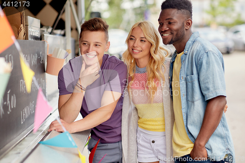 Image of happy customers or friends at food truck