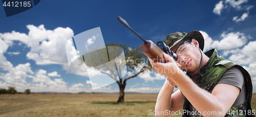 Image of soldier or hunter with gun aiming or shooting