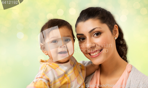 Image of portrait of happy mother with baby daughter