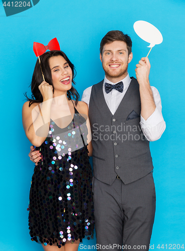 Image of happy couple with party props having fun