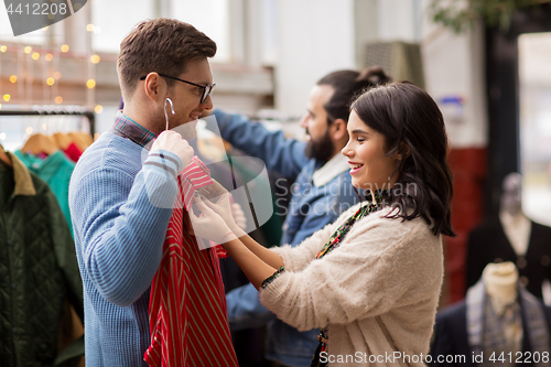 Image of couple choosing clothes at vintage clothing store