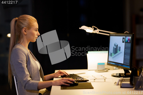 Image of graphic designer with computer at night office