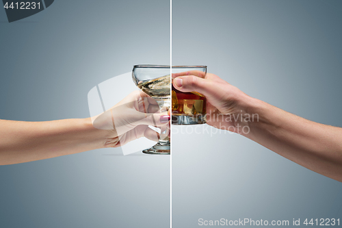 Image of Hand holding a glass of whiskey