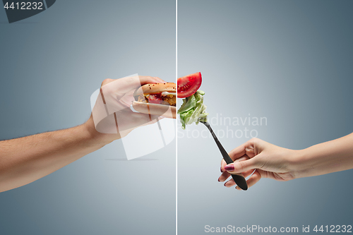 Image of Male hand holding tasty hamburger