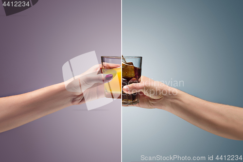 Image of beautiful woman holding orange juice