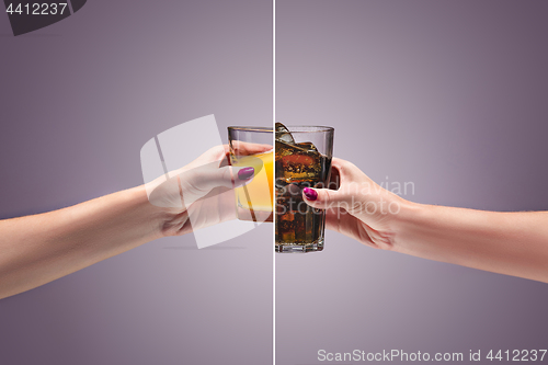 Image of beautiful woman holding orange juice